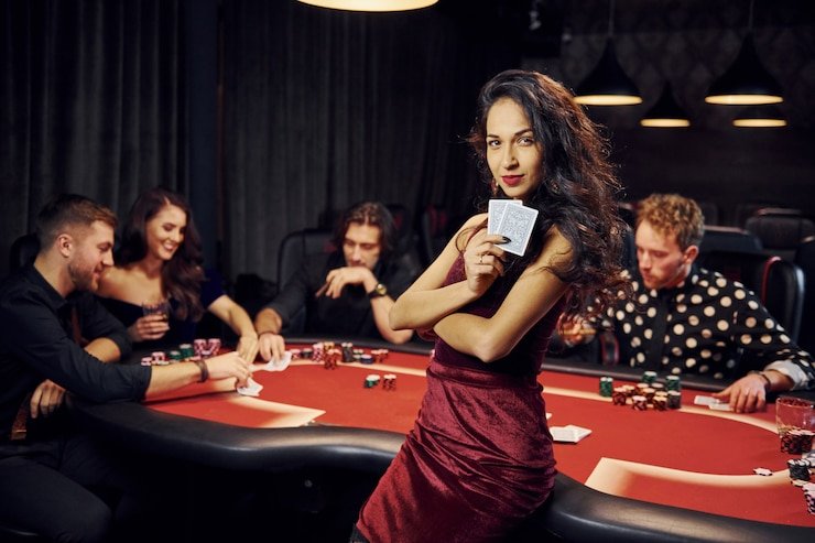 Ruang permainan live casino dengan dealer profesional di latar belakang
